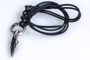 Silver pendant with arrow and heart